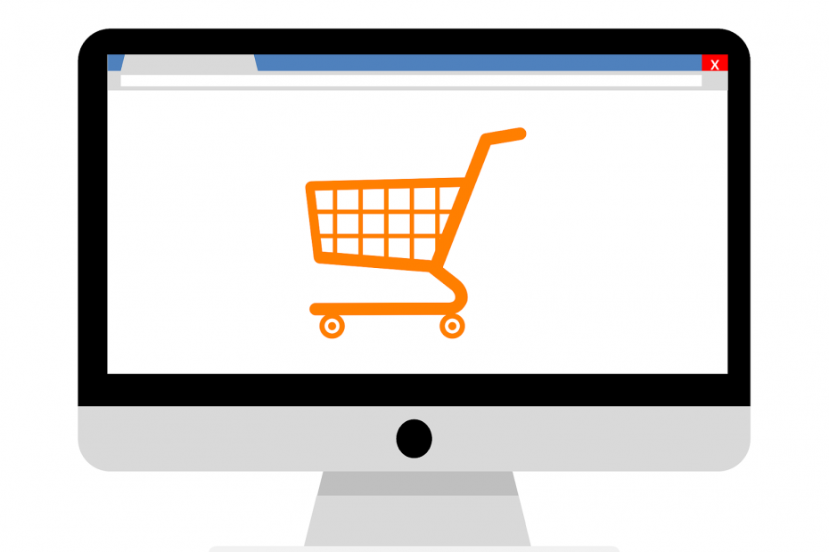 Desktop computer with orange shopping cart on screen to symbolize Woocommerce