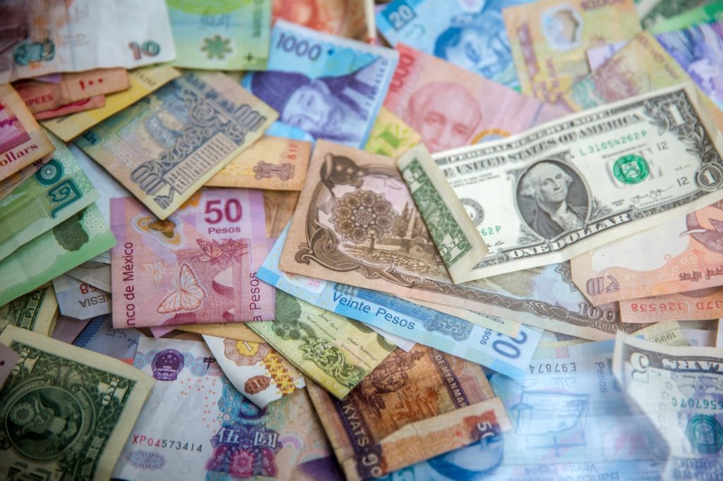 Multiple currencies laid out to show one of the benefits of using an international payment gateway of accepting multiple currencies.